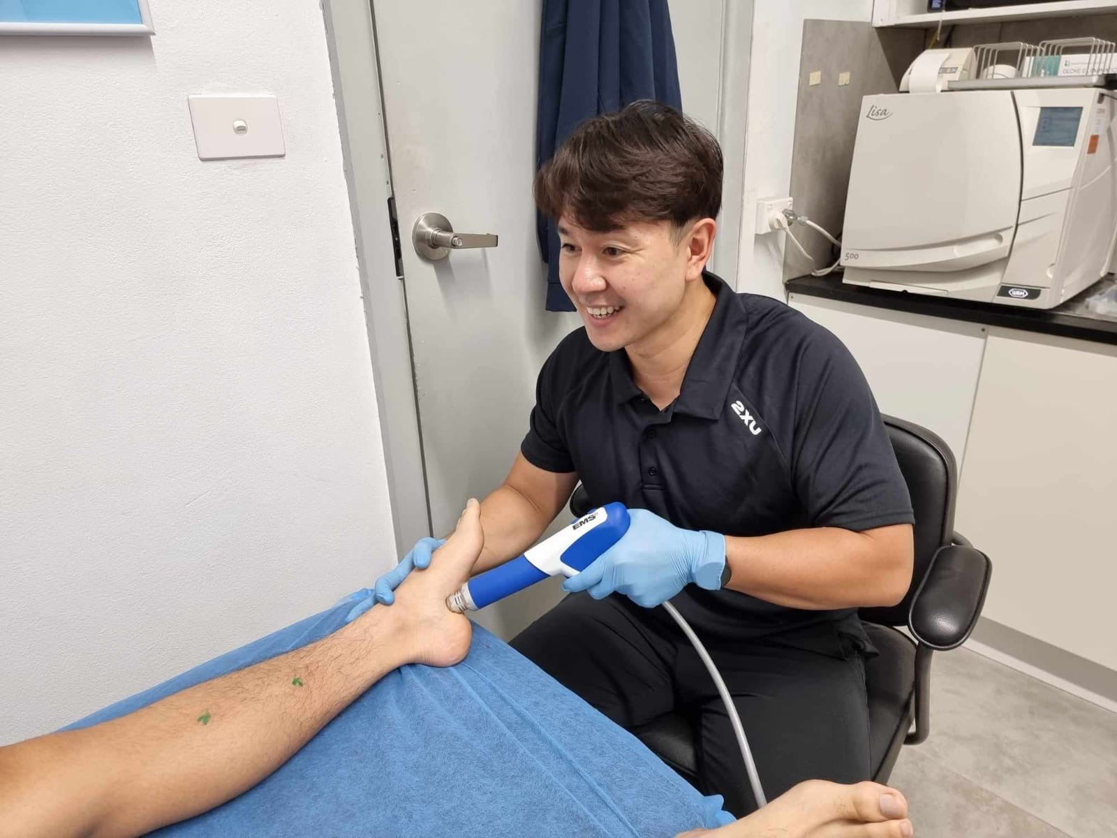 Podiatrist performing shockwave therapy